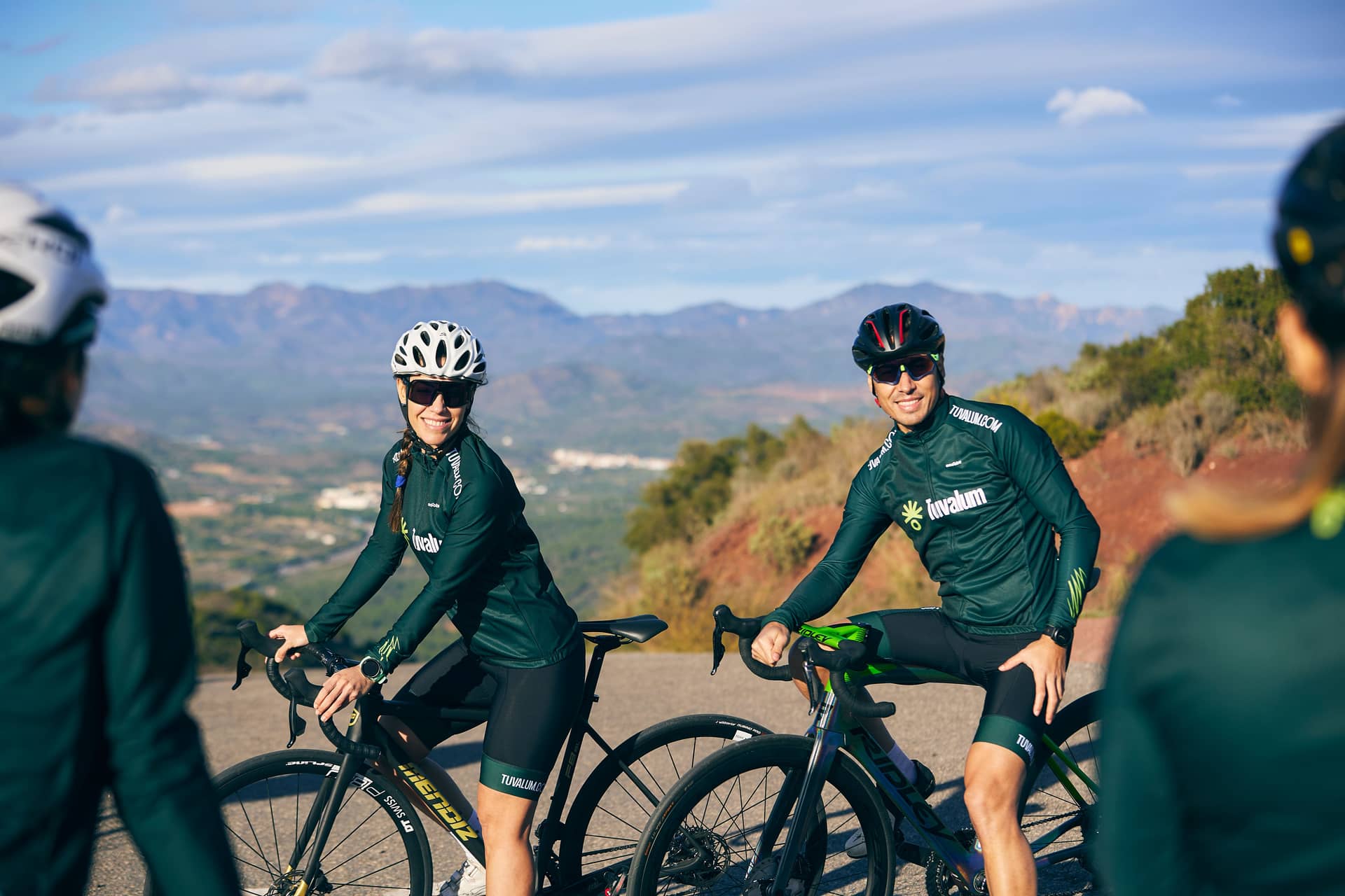 Cyclists with road bikes on outdoor mountain road with valley view