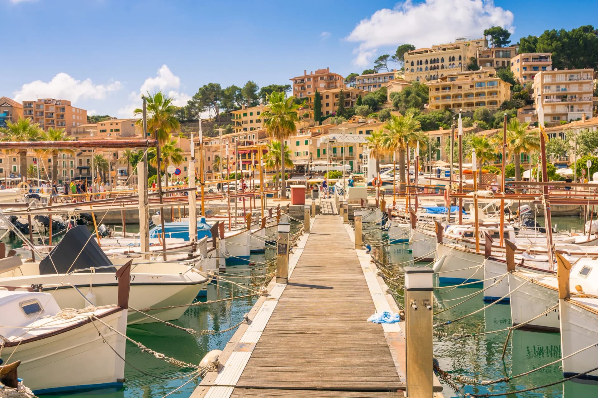 Beautiful Port de Soller in Mallorca full of motor boats and buildings on cliffs