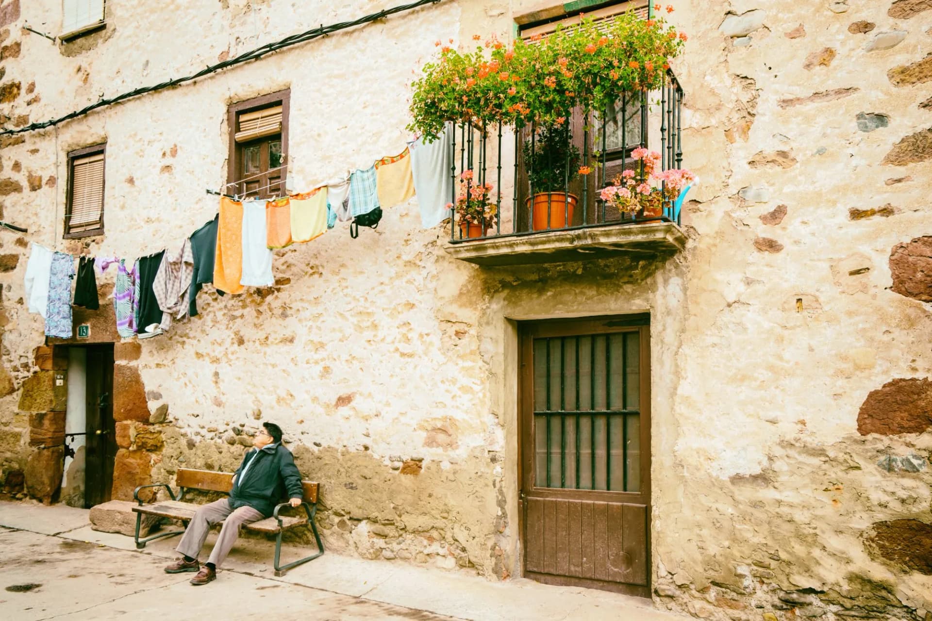 Old man on bench outside ezcaray