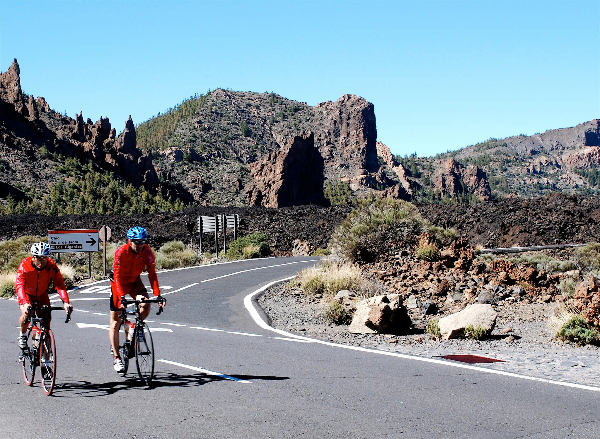 cyclists moving toward the peak of mt teide