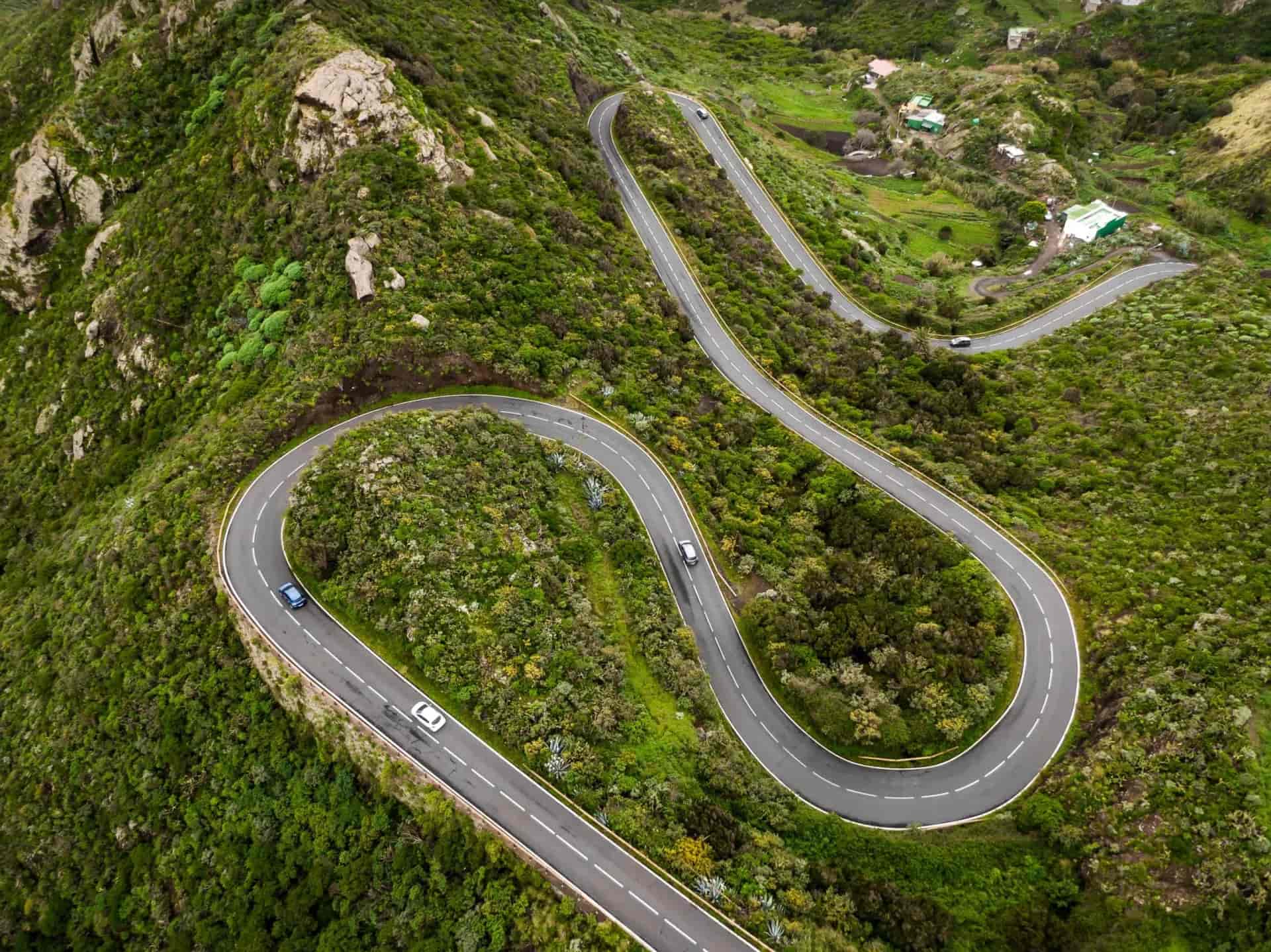 Winding mountain road on the green part of Tenerife island, Spain. Top aerial view.