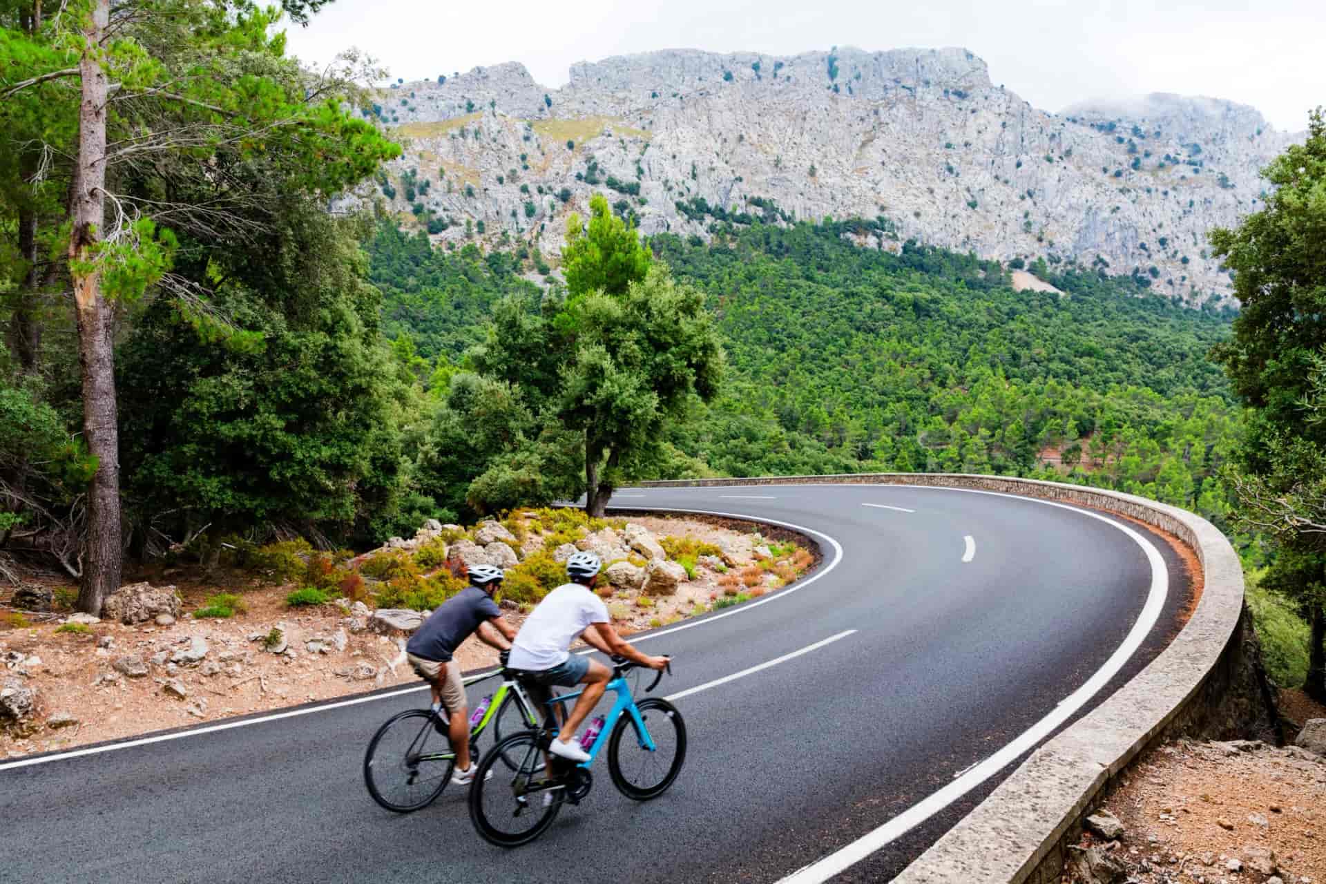 Cyclists riding up the Puig Major peak in Majorca