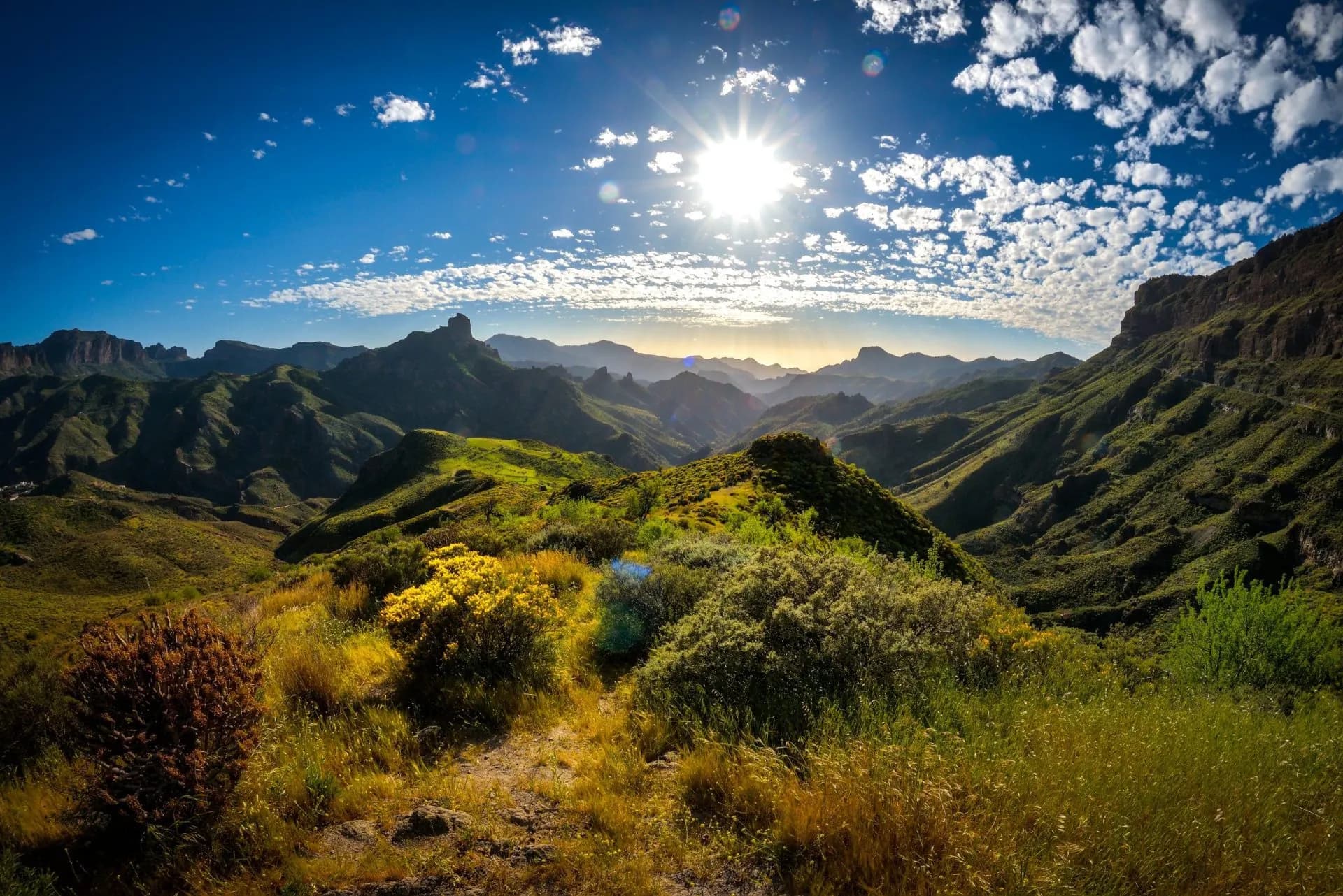 Mountainside landscape on Gran Canaria island, Spain, with bright sun and blue sky.
