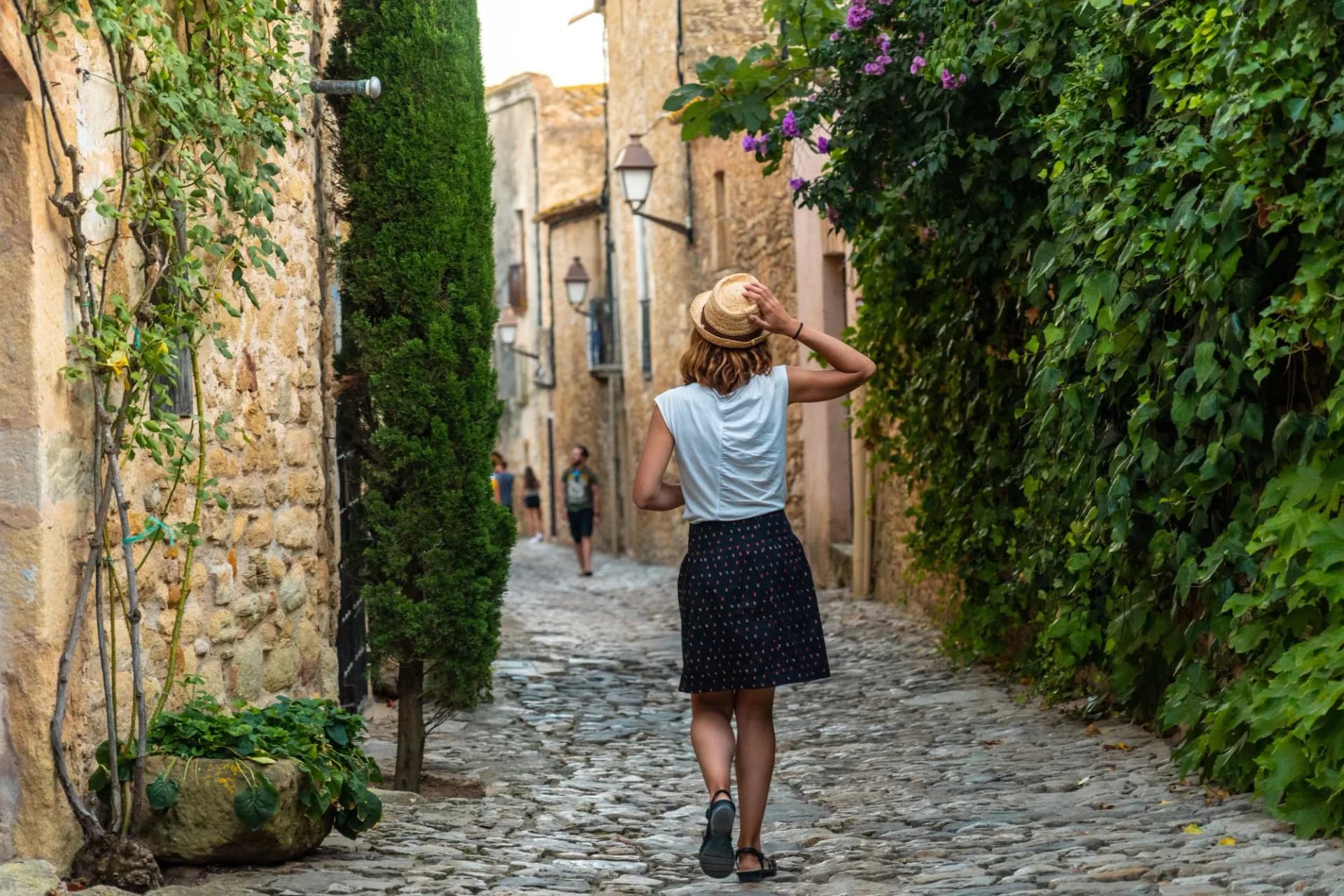 A tourist girl walking through the streets of Girona