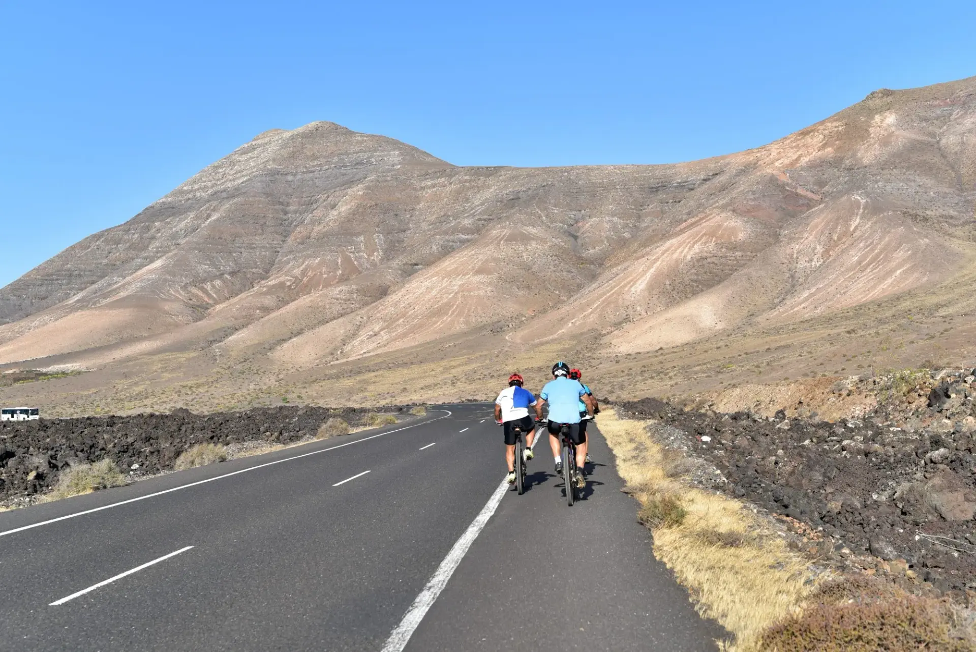 Cyclist riding through Timanfaya National park on Lanzarote