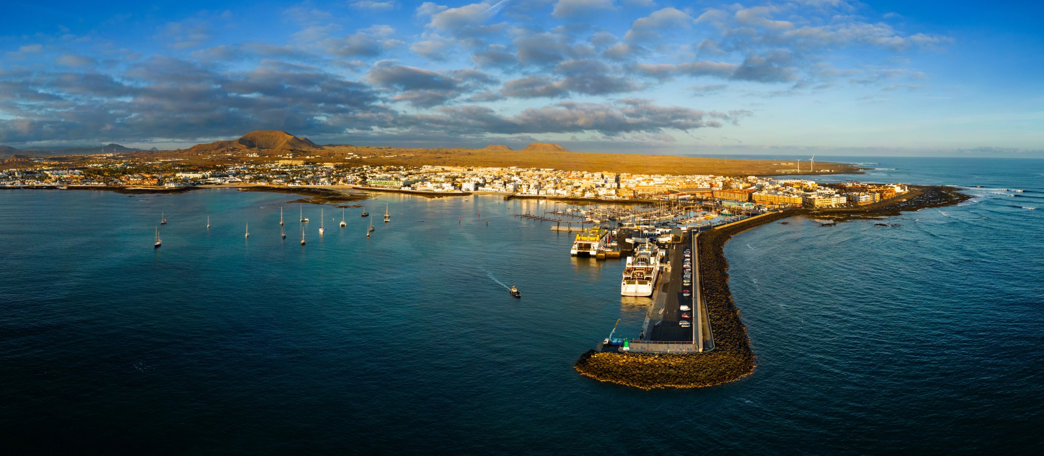 Spektakulär panoramautsikt över färjeterminalen, bryggan och hamnen tidigt på morgonen i Corralejo på Fuerteventura, Spanien