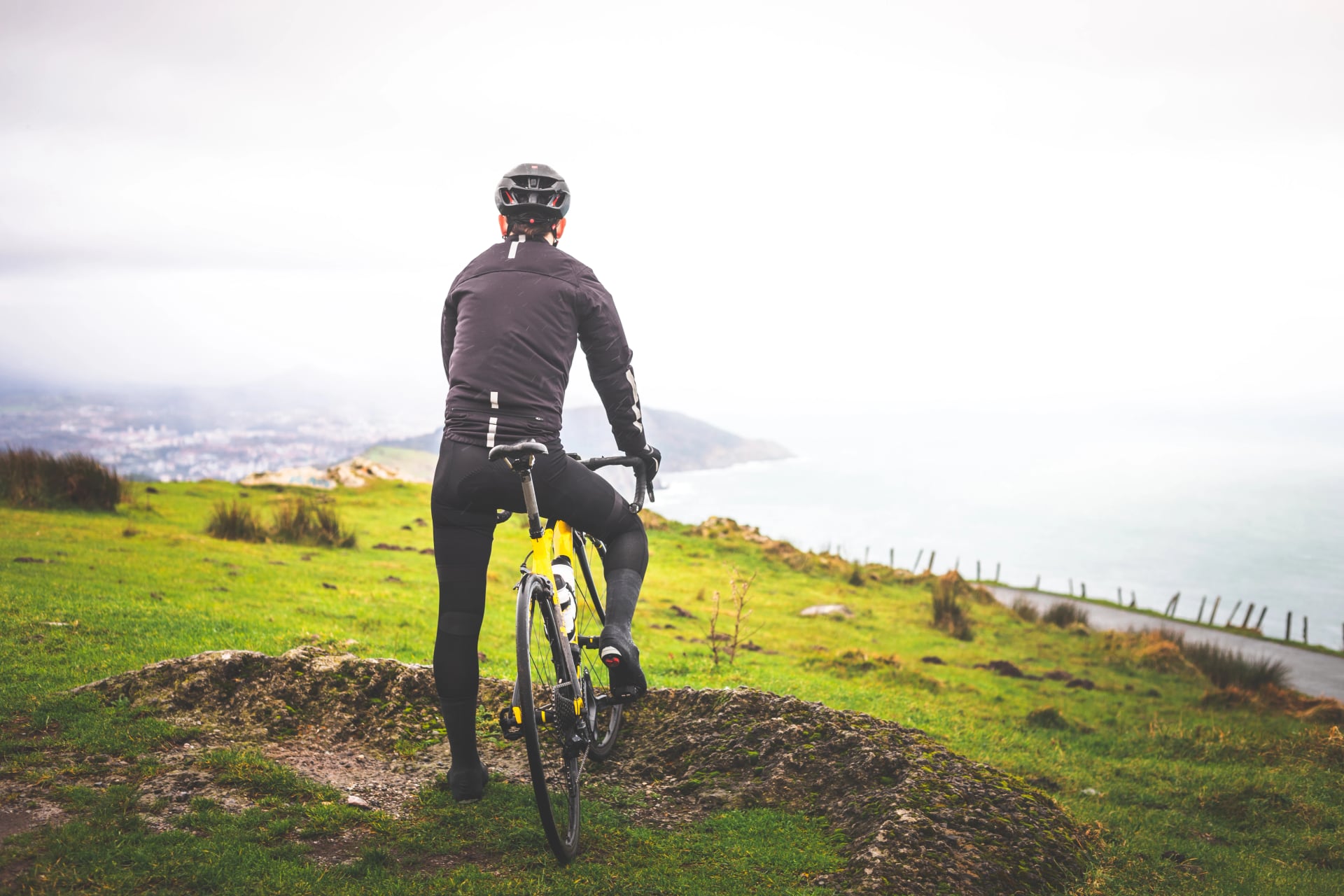 cyclist on the top of Jaizkibel mountain with views to the Basque Country.